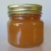 A jar of honey on top of a table.